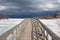 An old, wooden bridge crosses a section of frozen Georgian Bay waterfront in Collingwood