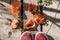 On an old wooden bridge in the garden, sneakers and orange poppy petals. Summer in the village. Top view