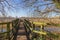 Old wooden bridge over the river. Early spring in England.