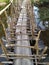 Old wooden bridge over the river. Rustic bridge in Asia. Rural landscape. Pathway over water.