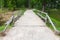 Old wooden bridge and walking lane in park