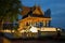 Old wooden Buddhist temple in the Santi Chai Prakan park in the evening twilight. Bangkok, Thailand