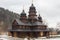 Old wooden building of the Holy Prophet Elijah Monastery in the Carpathian village of Yaremche in winter. Ukraine