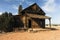 An old wooden building sits on the prairie of rural New Mexico.