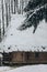 Old wooden cabin in Norway located in winter woods, rustic wood