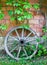 Old wooden cart wheel against wall