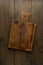 Old wooden chopping board. Food background. Overhead. Vertical. Dark plank