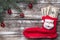 Old wooden Christmas background, a bracelet with a bauble tree, and Santa`s sock with a gift in the amount of money