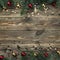 Old wooden Christmas background. Fir branches with baubles and gold stars. Space for text. Top view. Xmas square card