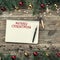 Old wooden Christmas background. Fir branches with baubles and gold stars. Xmas square card. Congratulation book. Top view