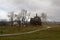 Old wooden Church built without a single nail, is located on the background of Suzdal on a rainy morning. Late in the fall. Rain.