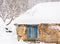 Old wooden cottage covered in snow