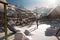 Old wooden cottages and wooden Romanian swings covered by snow. Cold winter day at countryside. Traditional Carpathian mountains