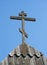 Old wooden cross against blue sky