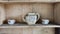 Old wooden cupboard with dirty and old clay pots