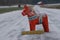 Old wooden Dalecarlian horse, Sweden symbol on a snow covered road