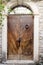 Old wooden door, arched stone wall.Rustic and retro style.