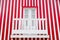 Old wooden door and a balcony on the background of the striped red and white wall. Portugal Windows. The exterior of