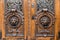 Old wooden door. Big two heads of lion on the front . vintage door knocker.