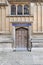 Old wooden door close-up within Old Bodleian Library Courtyard, Oxford, United Kingdom