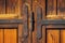 Old wooden door with crafted metal reinforcements