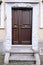 Old wooden door entrance to the house, concept of the beginning of a new life, magic portal, medieval European architecture,