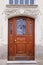 Old wooden door entrance to the house, concept of the beginning of a new life, magic portal, medieval European architecture,