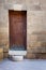 Old wooden door framed by bricks stone wall, Darb al Ahmar district, Old Cairo, Egypt