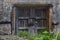 Old wooden door or gate and metal wires of the rusted lock. Outside the house, village, everything comes into disrepair