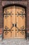 Old wooden door with metal door handle , wrought decoration
