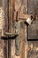 Old wooden door with a modern padlock. House security concept. Old entrance to the house