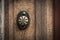 Old wooden door with round bronze handle