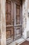 Old wooden door of a shabby demaged house facade. A small town in the mountains of Slovenia, Europe.