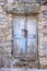 Old wooden door in stone wall in vintage style