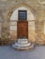 Old wooden door and window framed by arched bricks stone wall at the courtyard of al Razzaz historic house, Old Cairo, Egypt