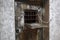 An old wooden door with a window for serving food in a prison, in a dungeon