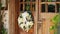 Old Wooden Door with a Wreath of Flowers in a Rural Romantic House in Summer