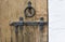 Old wooden door with wrought iron latch and handle in the form of a ring