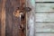 Old wooden doors with bronze handles and keyhole.