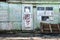 Old wooden doors on a collapsing building, a vintage barn, peeling paint, littered planks