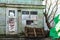 Old wooden doors on a collapsing building, a vintage barn, peeling paint, littered planks