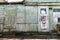 Old wooden doors on a collapsing building, a vintage barn, peeling paint, littered planks