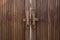 Old wooden doors locked with wooden crossbar