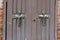 Old wooden doors with orthodox crosses at the entrance to the chapel as background.