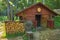 Old wooden dugout and wood storage in the forest