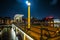 Old wooden Dutch bridge at night time against rush clouds.