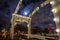 Old wooden Dutch bridge at night time against rush clouds.