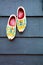 Old wooden Dutch shoes - klomps. A pair of klomps against the background of a wooden wall. Traditions of Holland. Background