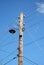 Old wooden electric post power pole. Power line. Wooden Utility Pole with light Bulb.