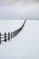 Old wooden farme fence in a winter rural landscape